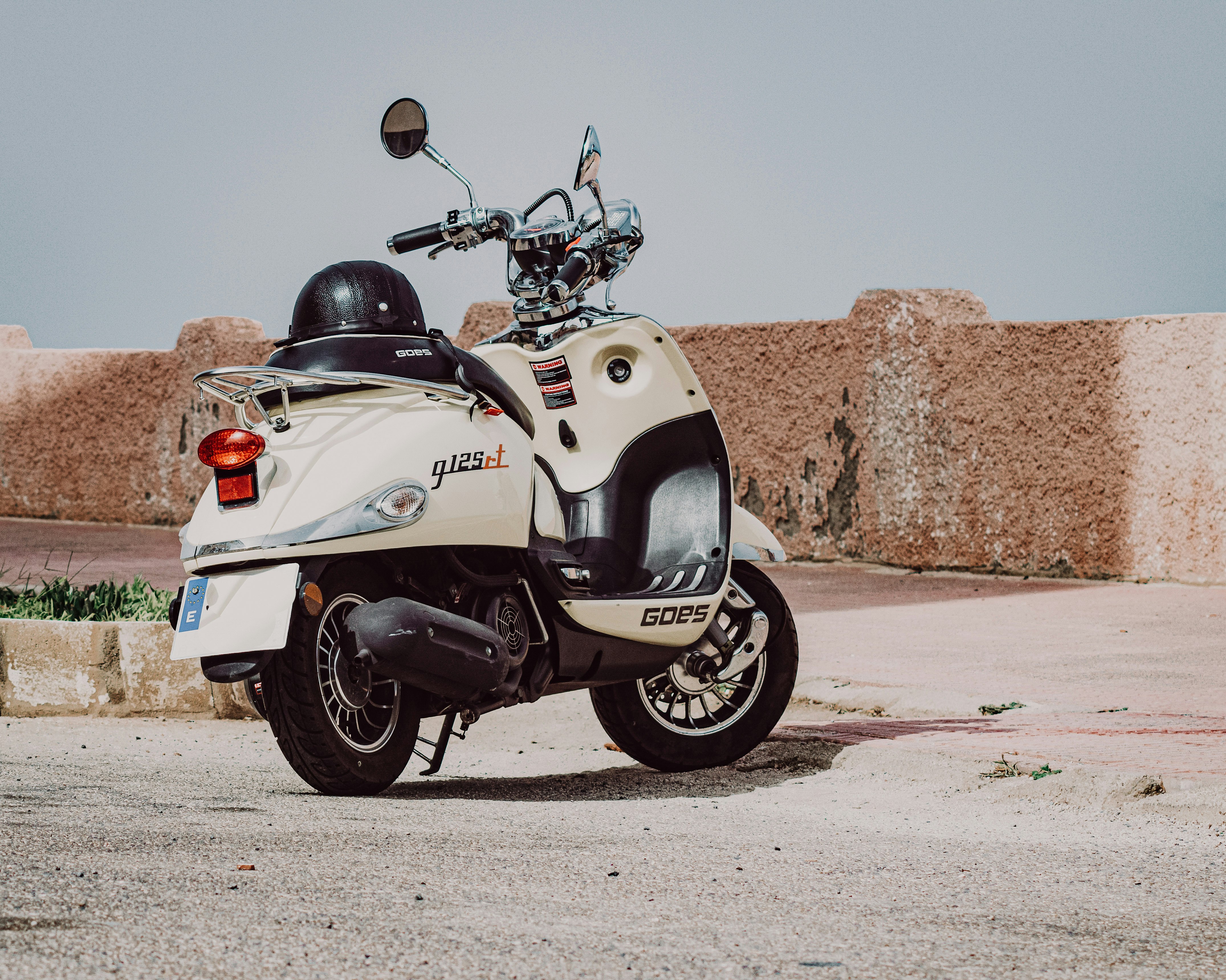 white and black sports bike on brown sand during daytime